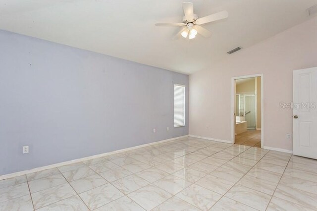 tiled empty room featuring ceiling fan and vaulted ceiling