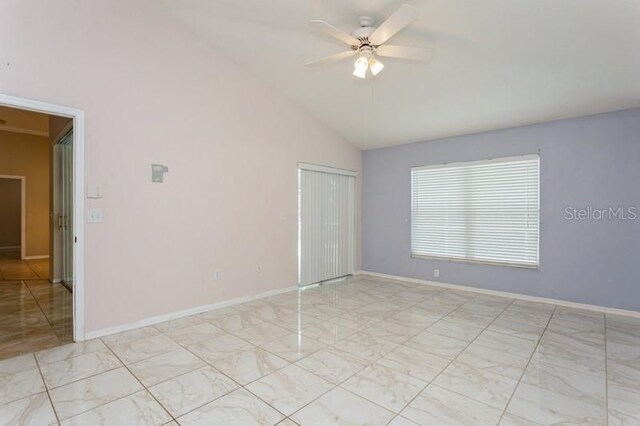 unfurnished room with light tile patterned flooring, high vaulted ceiling, and ceiling fan