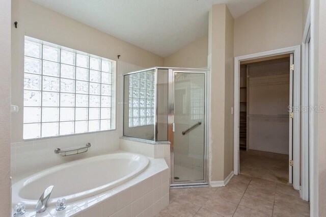 bathroom featuring plus walk in shower, tile patterned flooring, and plenty of natural light