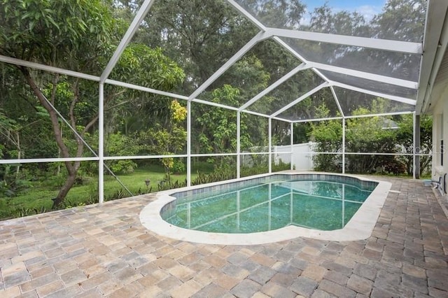 view of pool with a patio area and a lanai