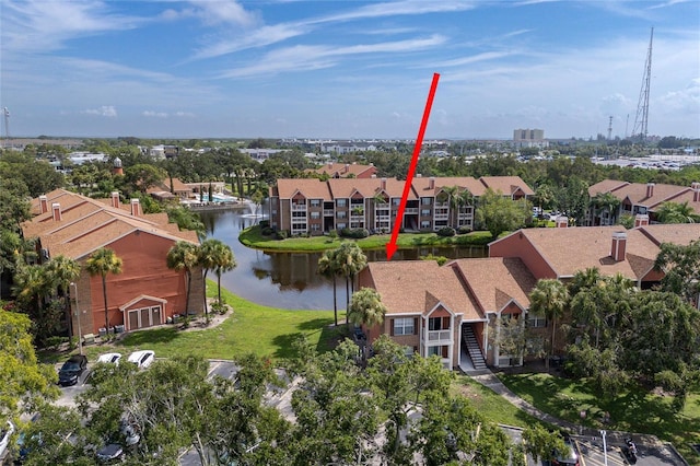 drone / aerial view featuring a water view and a residential view