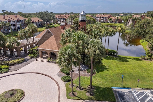 birds eye view of property featuring a water view and a residential view