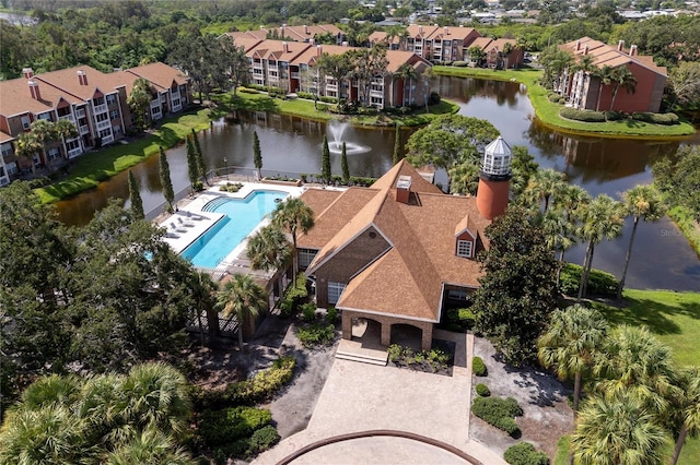 drone / aerial view with a water view and a residential view