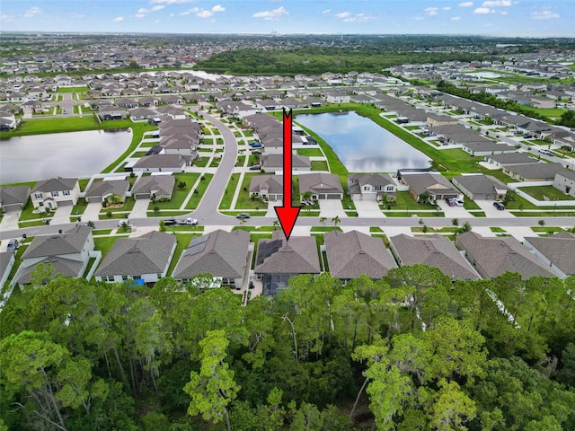 birds eye view of property with a water view