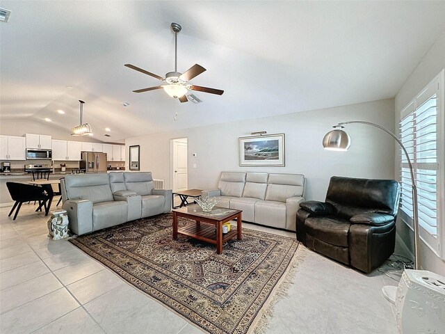 tiled living room featuring lofted ceiling and ceiling fan