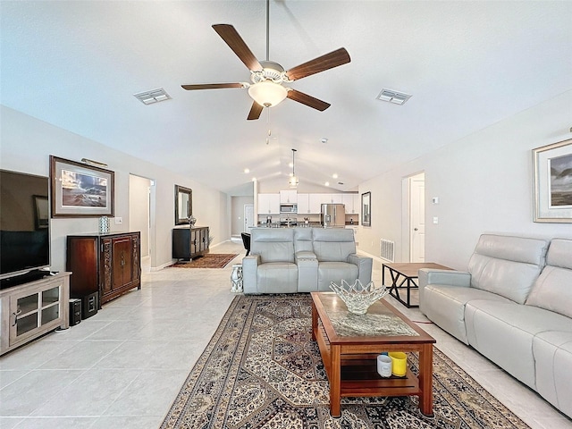 living room with light tile patterned floors, vaulted ceiling, and ceiling fan