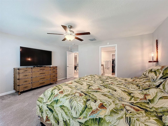 carpeted bedroom featuring a textured ceiling, ceiling fan, and ensuite bath