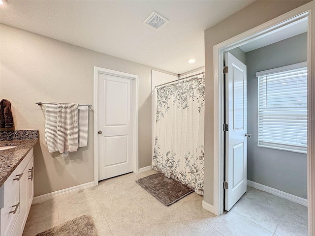 bathroom featuring a shower with curtain, tile patterned flooring, and vanity