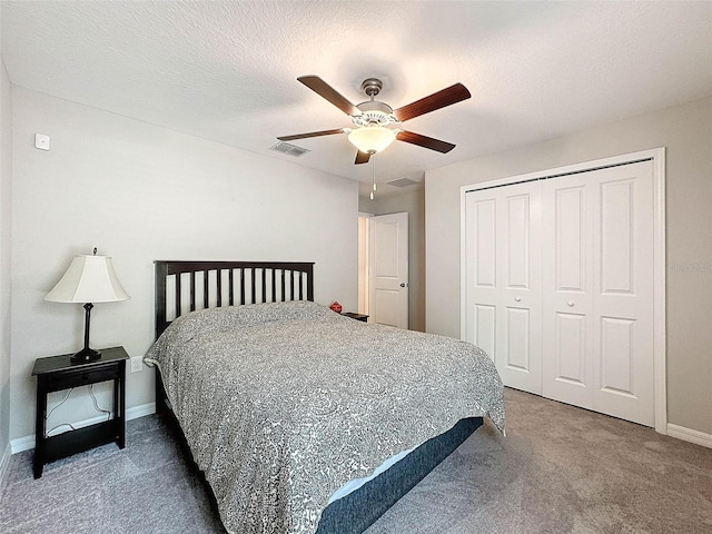 carpeted bedroom featuring a textured ceiling, ceiling fan, and a closet