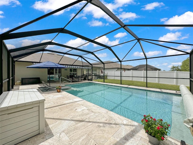 view of swimming pool with a lanai and a patio area