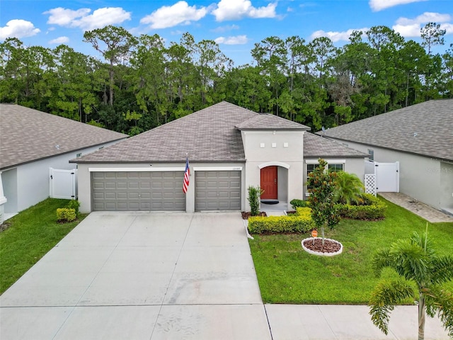 view of front of home with a garage and a front lawn