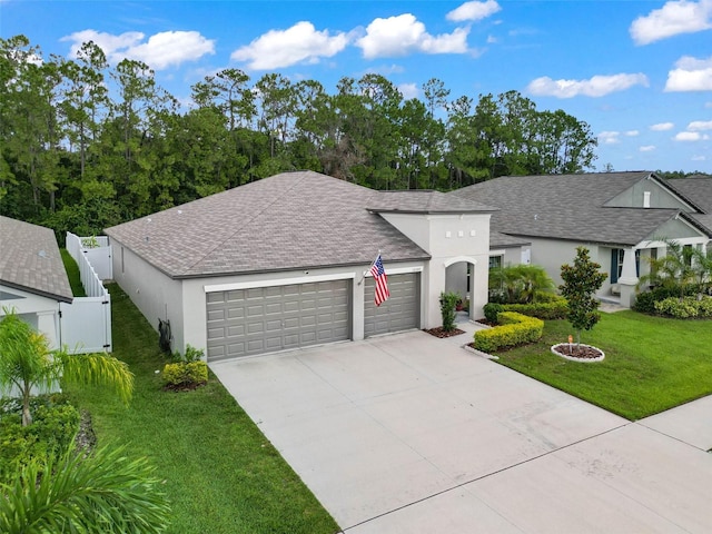 view of front of house featuring a front lawn and a garage