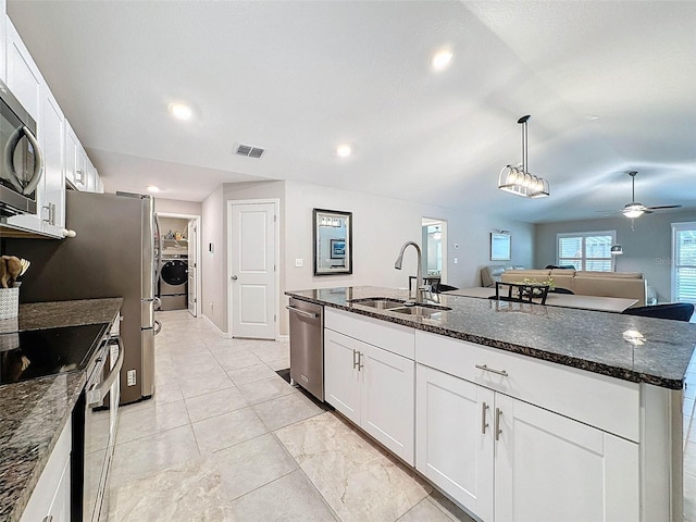 kitchen featuring white cabinetry, appliances with stainless steel finishes, sink, and a kitchen island with sink