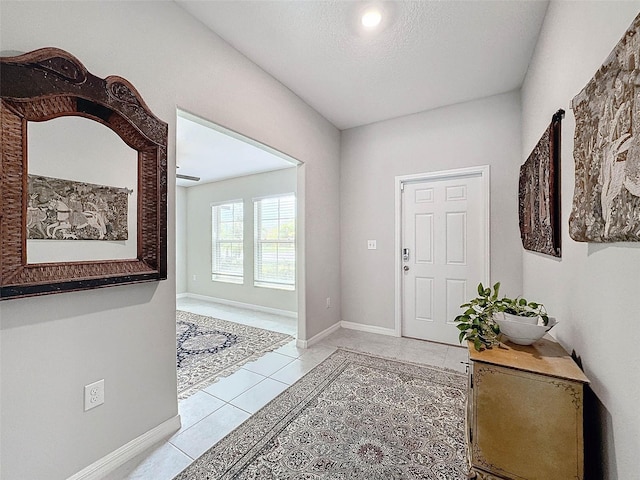 tiled entryway featuring a textured ceiling