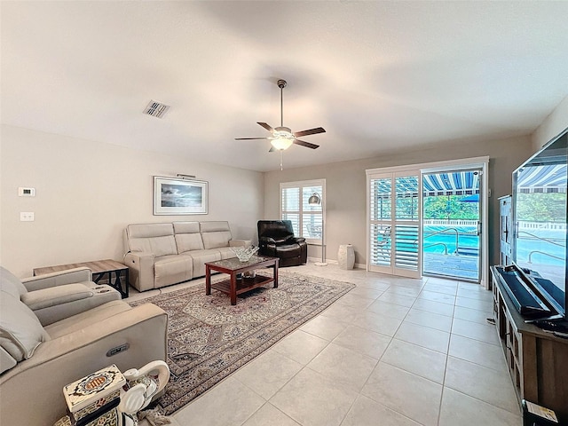 tiled living room with ceiling fan