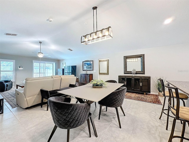 dining area featuring light tile patterned flooring and ceiling fan