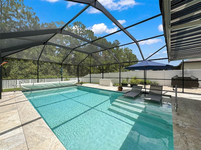 view of swimming pool featuring glass enclosure, a patio area, and area for grilling