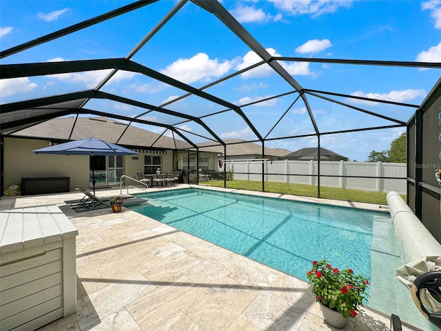 view of pool with glass enclosure and a patio area