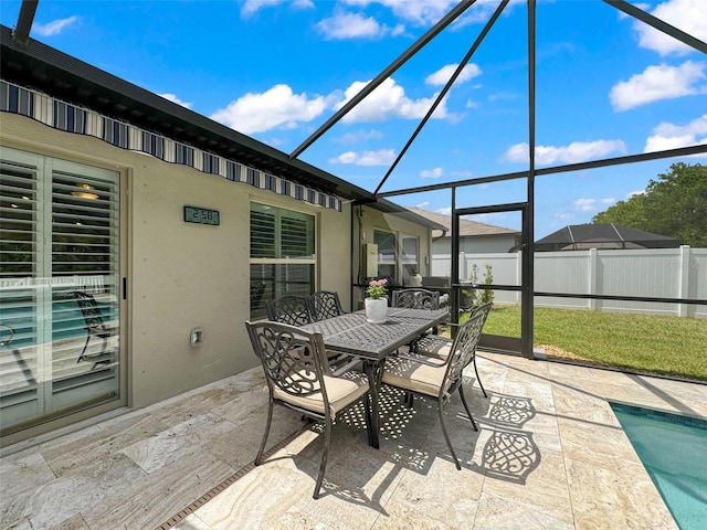 view of patio featuring a lanai