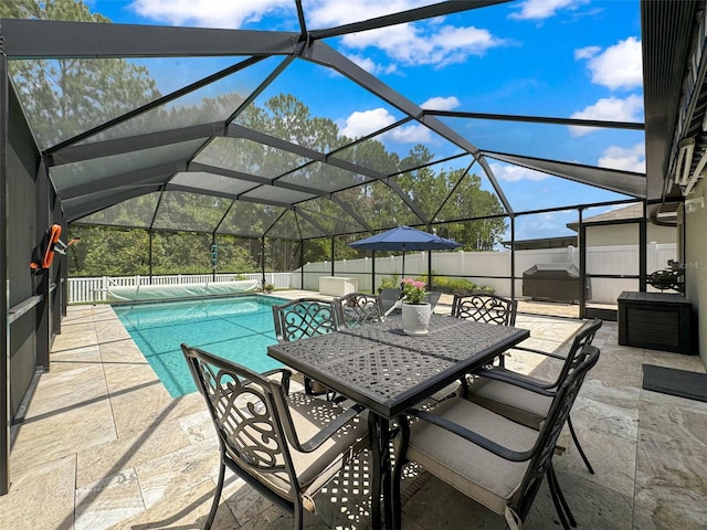 view of pool featuring glass enclosure and a patio area