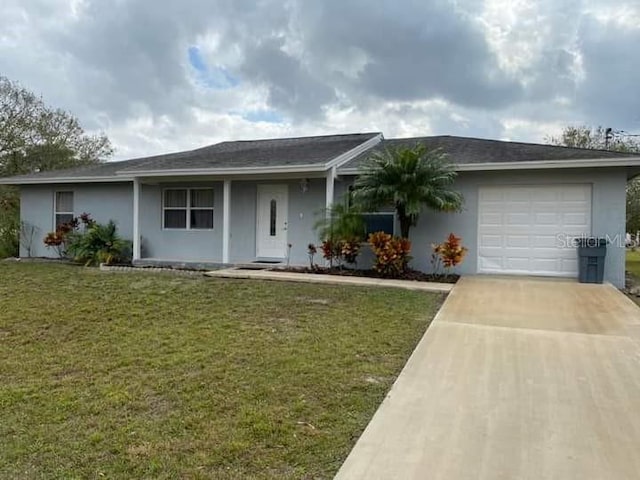 ranch-style house featuring a garage and a front lawn