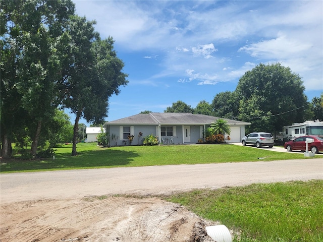 single story home featuring covered porch, a garage, and a front lawn