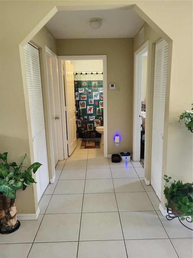 hallway featuring light tile patterned floors