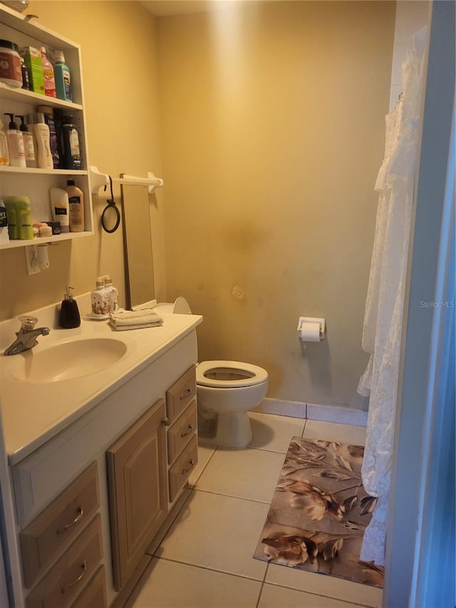 bathroom with vanity, toilet, and tile patterned floors