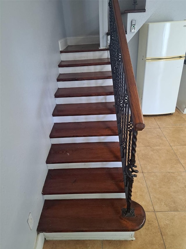 stairway featuring tile patterned floors