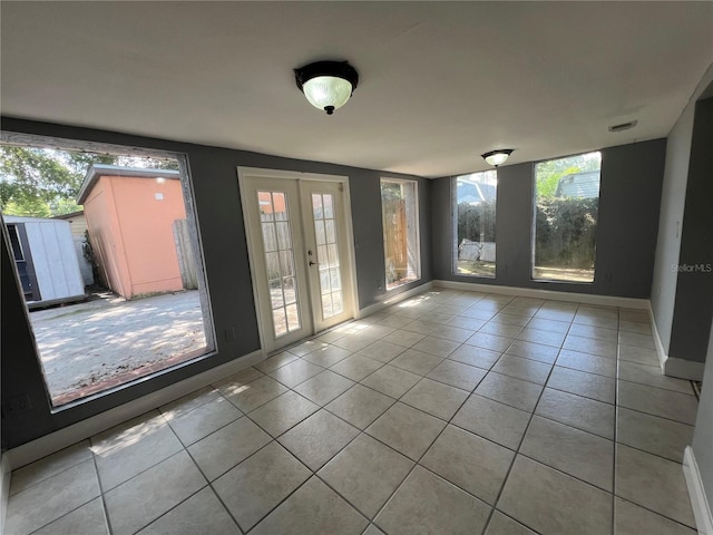 tiled empty room with french doors