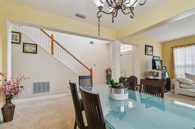 dining room featuring stairway, carpet, visible vents, and a notable chandelier