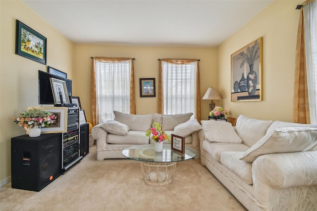 living area with a wealth of natural light and carpet