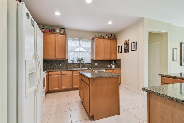 kitchen featuring a center island, light tile patterned floors, decorative backsplash, dark stone countertops, and white fridge with ice dispenser