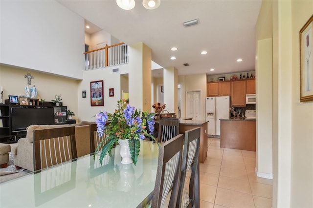 dining space with light tile patterned floors, visible vents, and recessed lighting