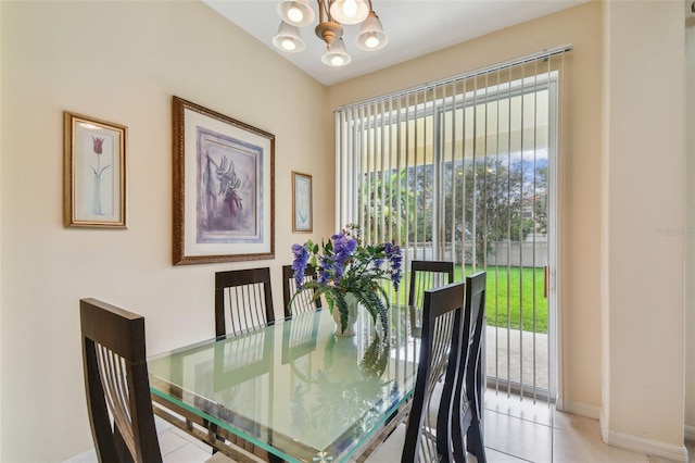 dining room featuring light tile patterned floors, baseboards, and a chandelier