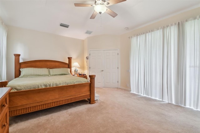 bedroom featuring light carpet, visible vents, and a ceiling fan