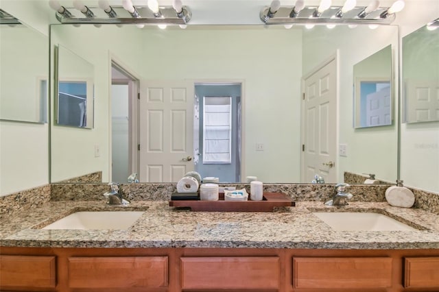 full bath featuring double vanity and a sink