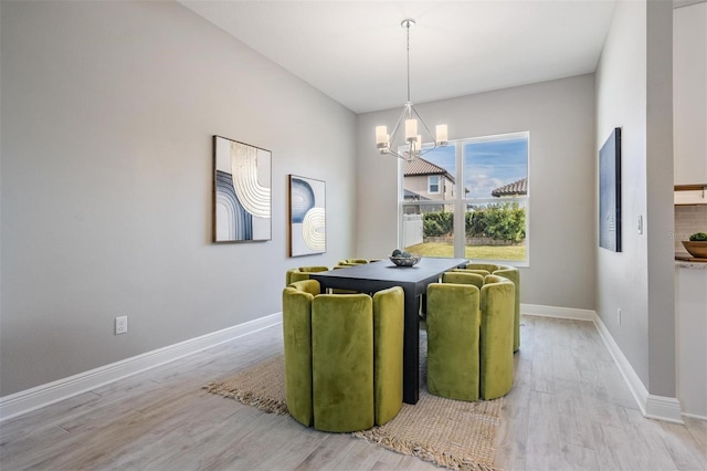 dining area featuring light hardwood / wood-style floors and a chandelier