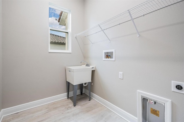 laundry area featuring hookup for an electric dryer, washer hookup, and light wood-type flooring