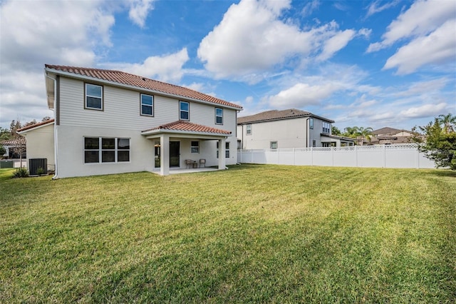 back of house with a lawn, cooling unit, and a patio area