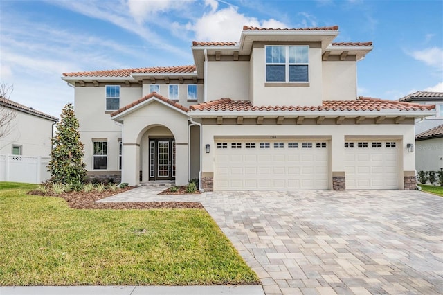 mediterranean / spanish home with a front yard and a garage