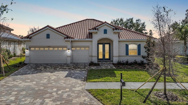 mediterranean / spanish house featuring french doors and a yard