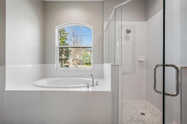 bathroom with plenty of natural light and shower with separate bathtub