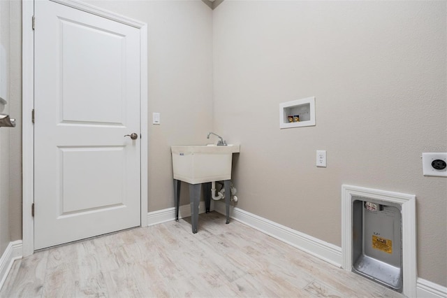 laundry room featuring washer hookup, light hardwood / wood-style floors, and electric dryer hookup