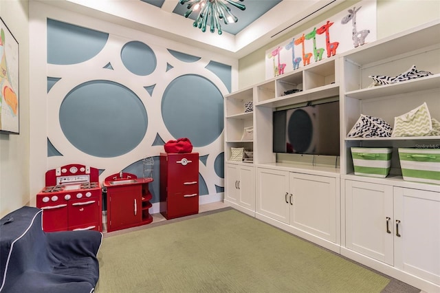 playroom with carpet flooring and a chandelier