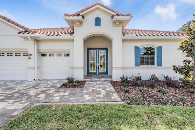 view of front of home featuring french doors and a garage