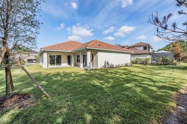 rear view of house featuring a lawn