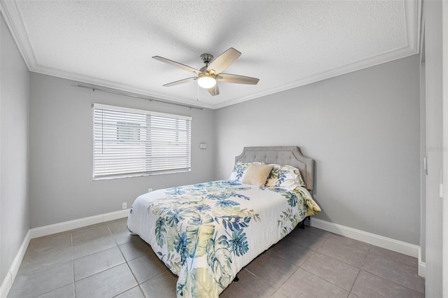 tiled bedroom with a textured ceiling, ceiling fan, and crown molding