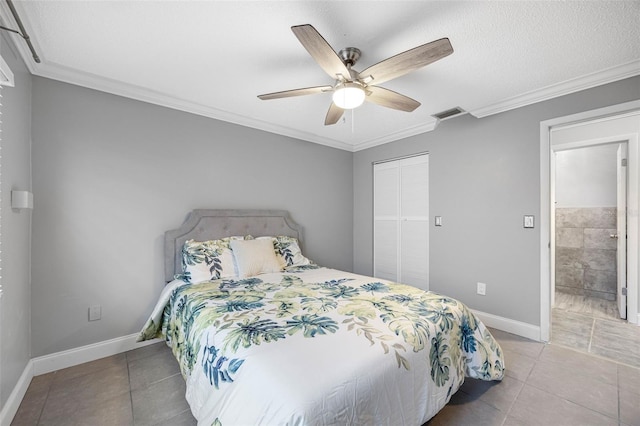 bedroom featuring ceiling fan, a textured ceiling, a closet, light tile patterned floors, and ornamental molding