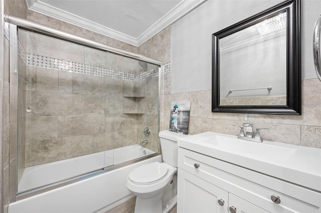 full bathroom featuring vanity, crown molding, toilet, enclosed tub / shower combo, and tile walls